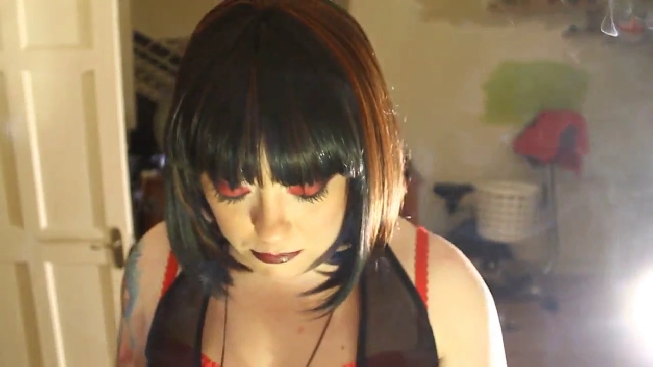 Tina Smua is a voluptuous and dominant woman who loves to indulge in her smoking habit. In this video, she takes her time smoking a filterless cigarette in a holder, exhaling smoke and blowing it into the camera.